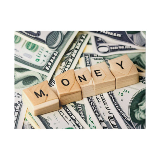Wooden alphabet blocks spell MONEY on a background of scattered U.S. dollar bills.
