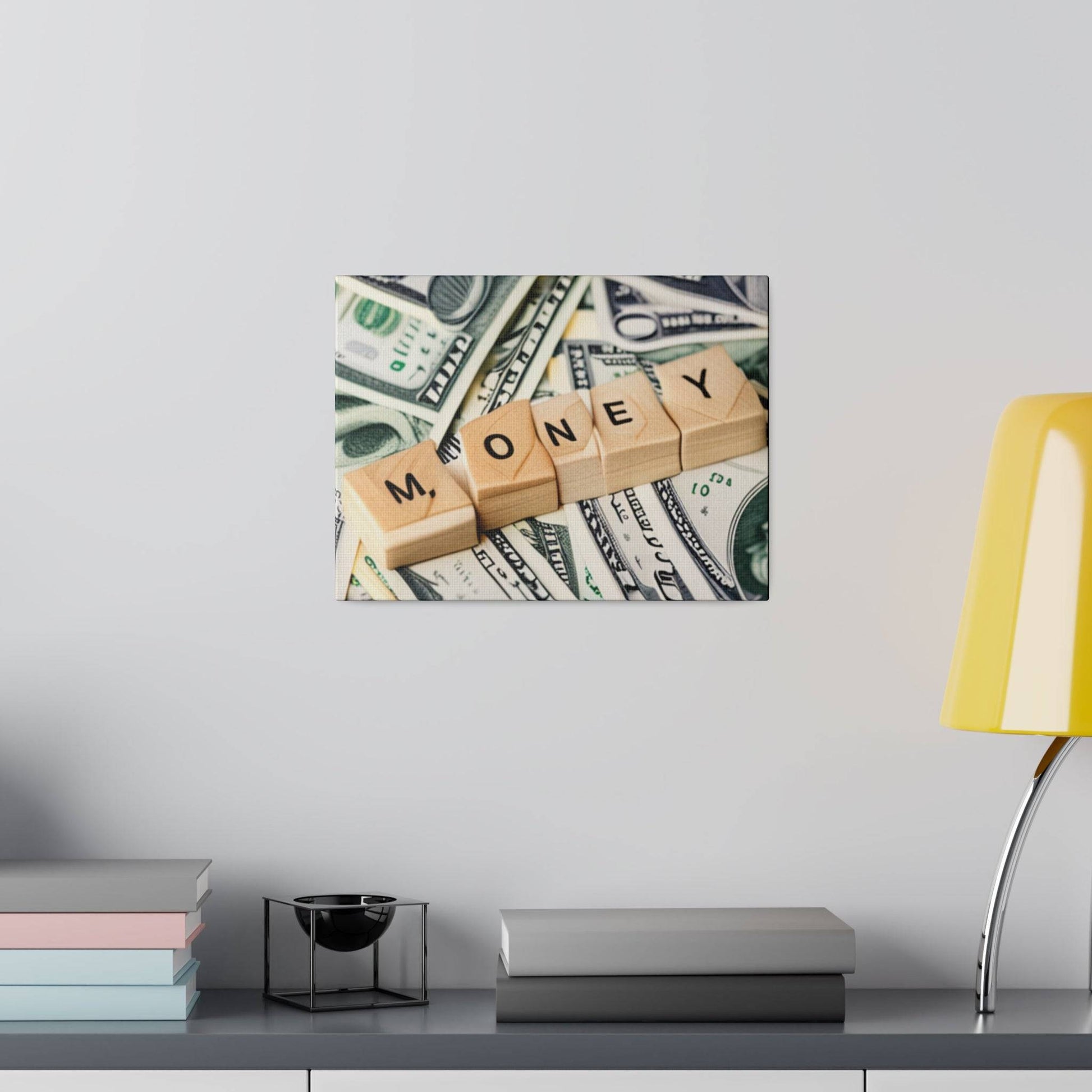 Framed photo on wall showing wooden letter blocks spelling MONEY laid over scattered U.S. dollar bills.