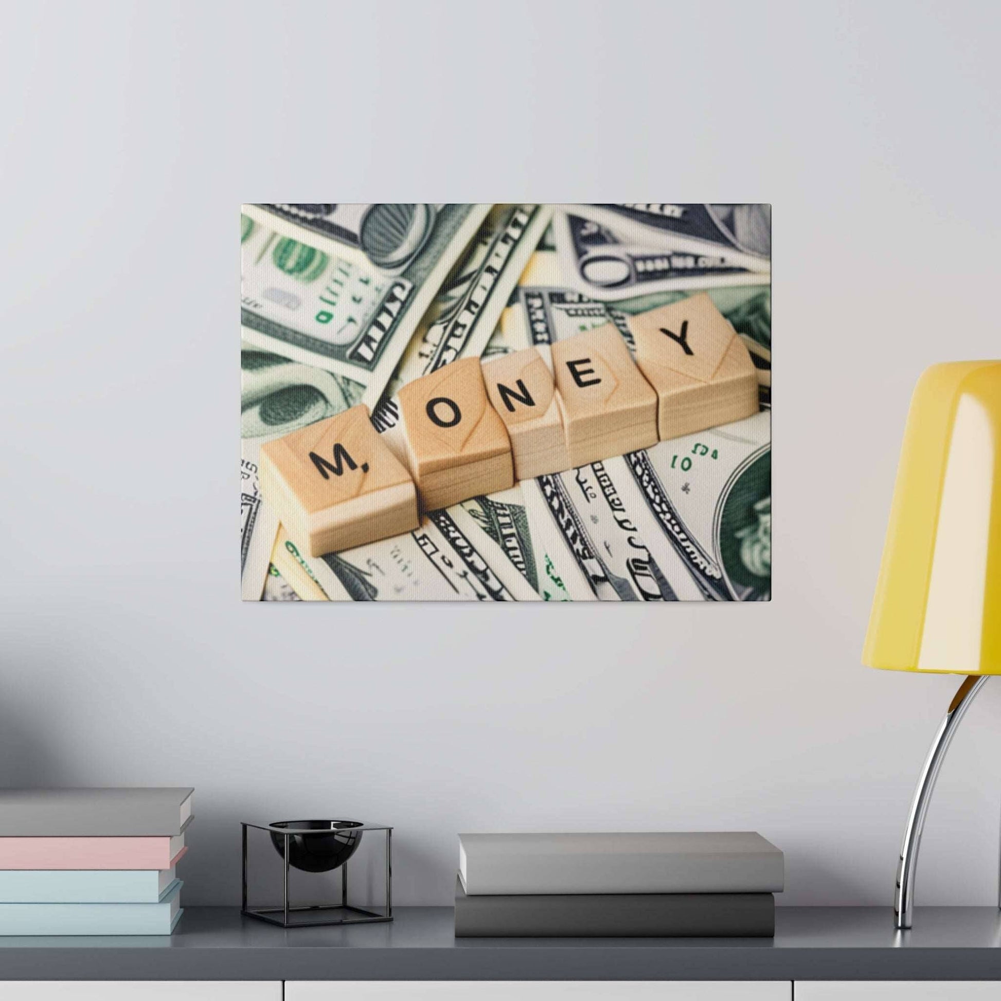 Wooden letter cubes spell MONEY laid over scattered U.S. dollar bills on a canvas print.