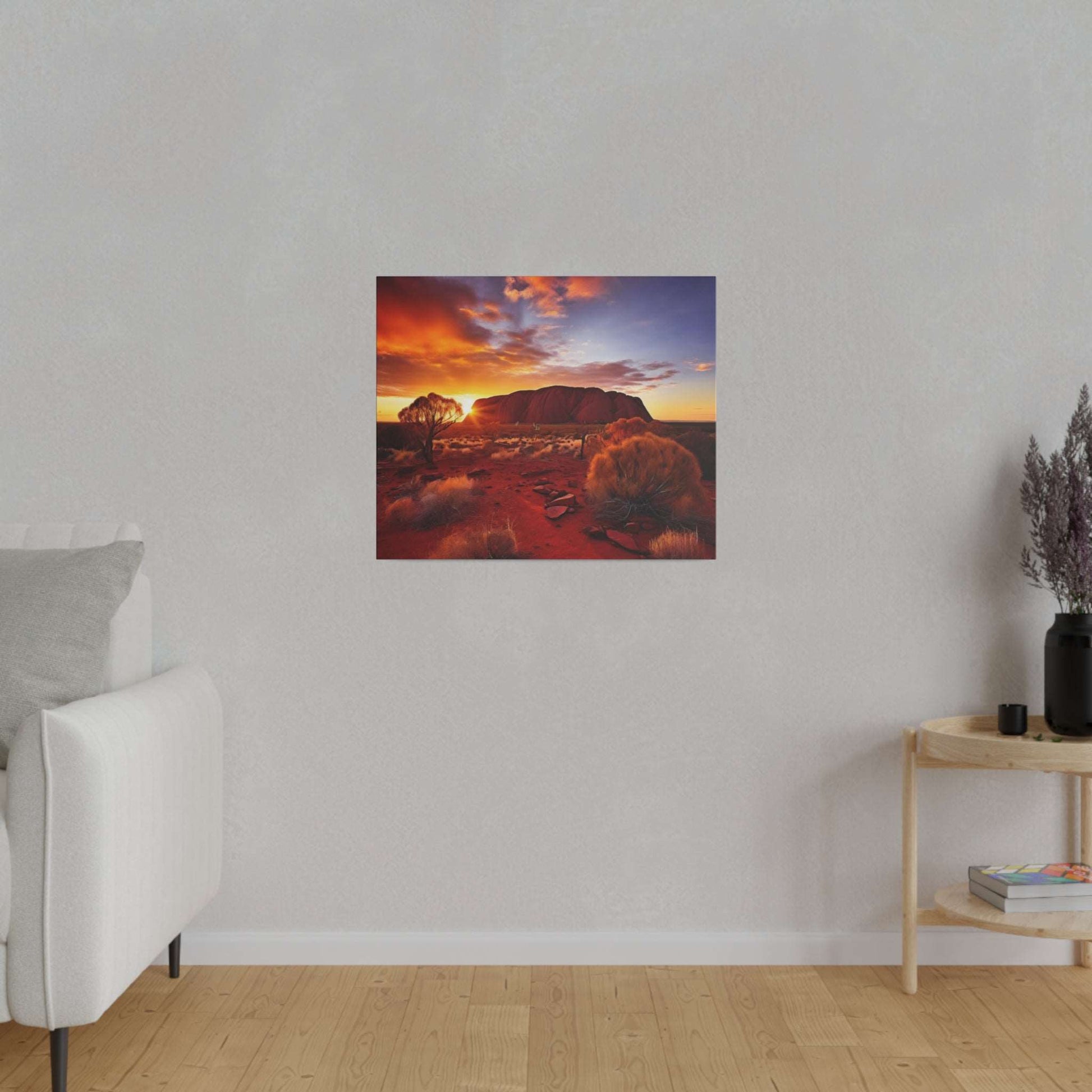 Square canvas print of a desert scene at sunset with Uluru, red soil, and sparse bushes.