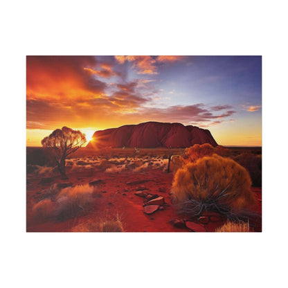 Canvas print of Uluru at sunset, with orange desert foreground, shrubs, and a purple-blue sky.