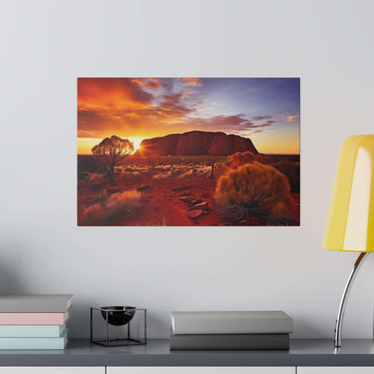 Canvas print of Uluru at sunset, depicting a red desert landscape with a large rock formation and sparse vegetation.