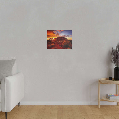 Small square canvas print of a desert scene with Uluru at sunset mounted on a light gray wall.