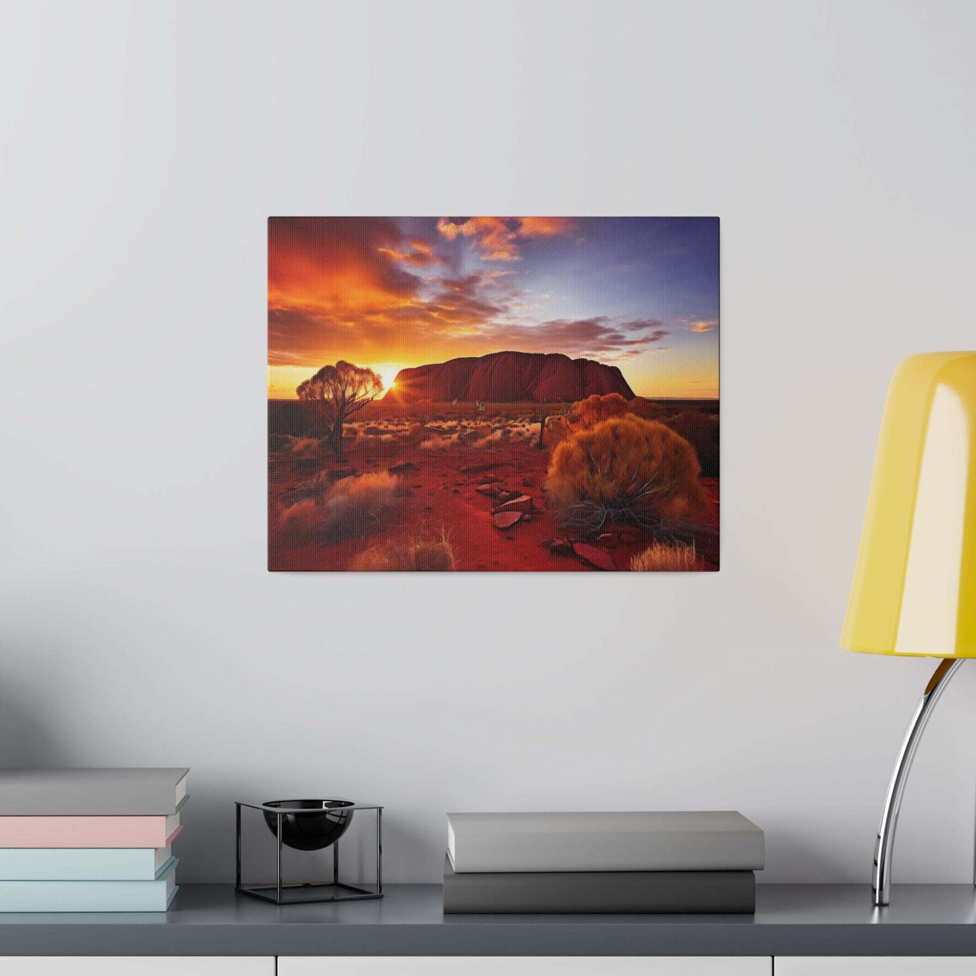 Square canvas print depicting Uluru at sunset, with red desert and orange-yellow sky.