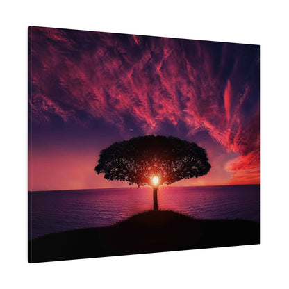 Tree on a small hill by the ocean at sunset, with the sun visible through the tree’s center and pink-to-purple-red clouds above.