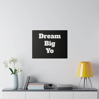 Black square wall art with bold white text 'Dream Big Yo' mounted above a gray