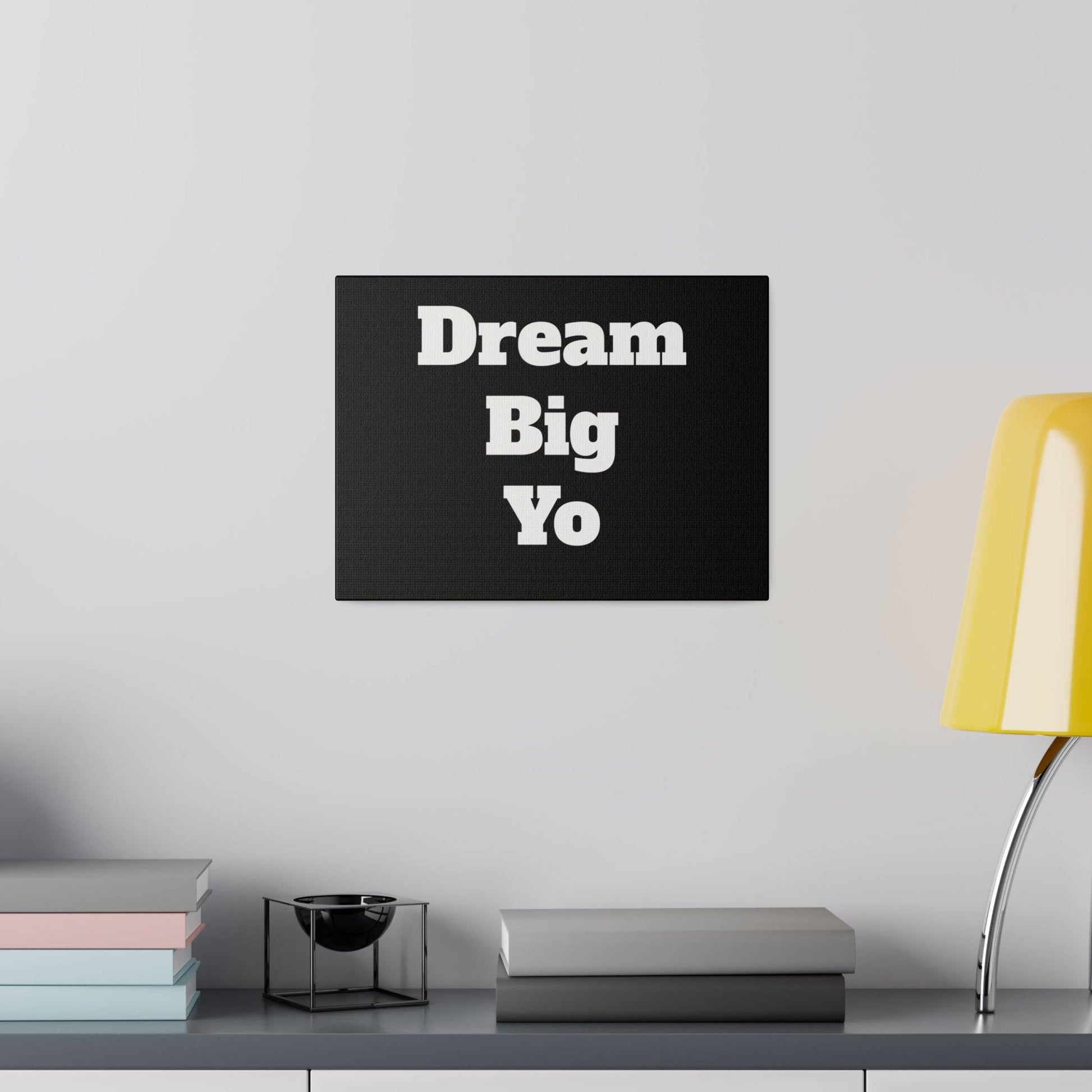 Black rectangular canvas wall art displaying the phrase 'Dream Big Yo' in large white bold letters.
