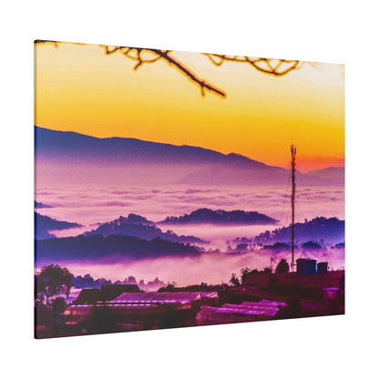 Sunrise over a hillside town with purple fog rolling across layered hills and a tall antenna silhouette.