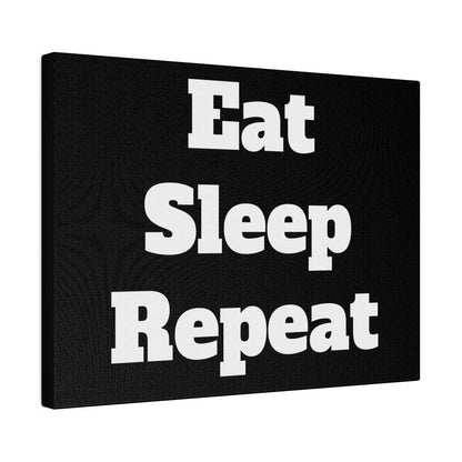 Black canvas wall art with large white bold text reading Eat Sleep Repeat.