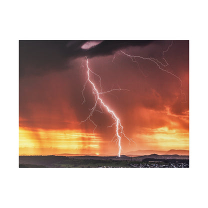Lightning bolt descends to the ground over a glowing orange sunset with dark storm clouds.