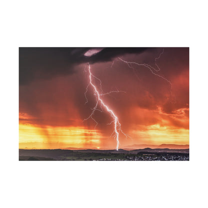 Lightning bolt hits the ground over a rural landscape at sunset with orange and purple storm clouds.