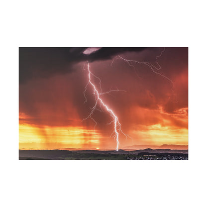 Large photograph of a bright white lightning bolt striking the ground during a dramatic orange sunset over a rural landscape.