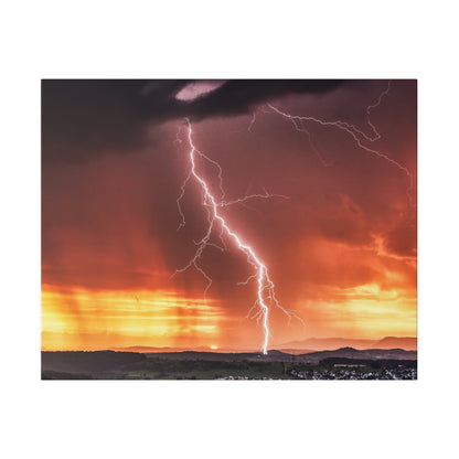 Bright white lightning bolt strikes the ground over an orange sunset sky and distant hills.