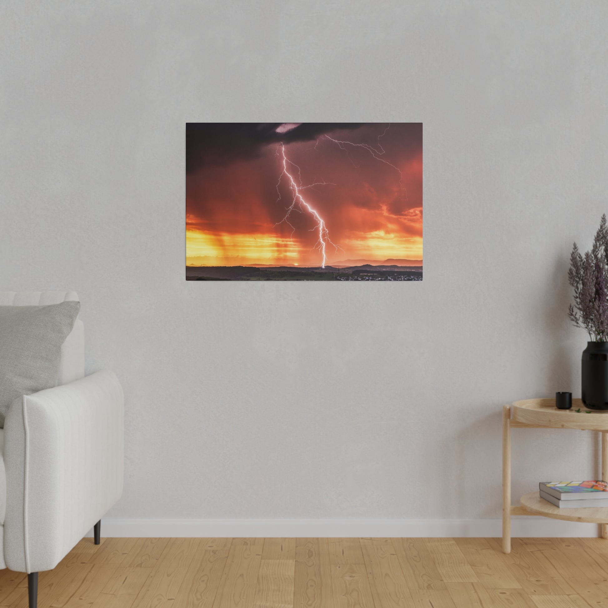 Framed photograph of a bright lightning bolt striking the horizon during a fiery sunset.