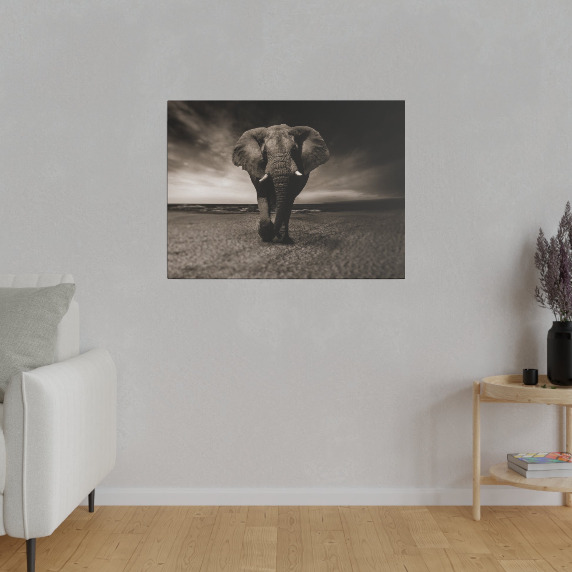 A powerful elephant stands at the ocean front, its silhouette beautifully framed against the sweeping seascape and dramatic sky.