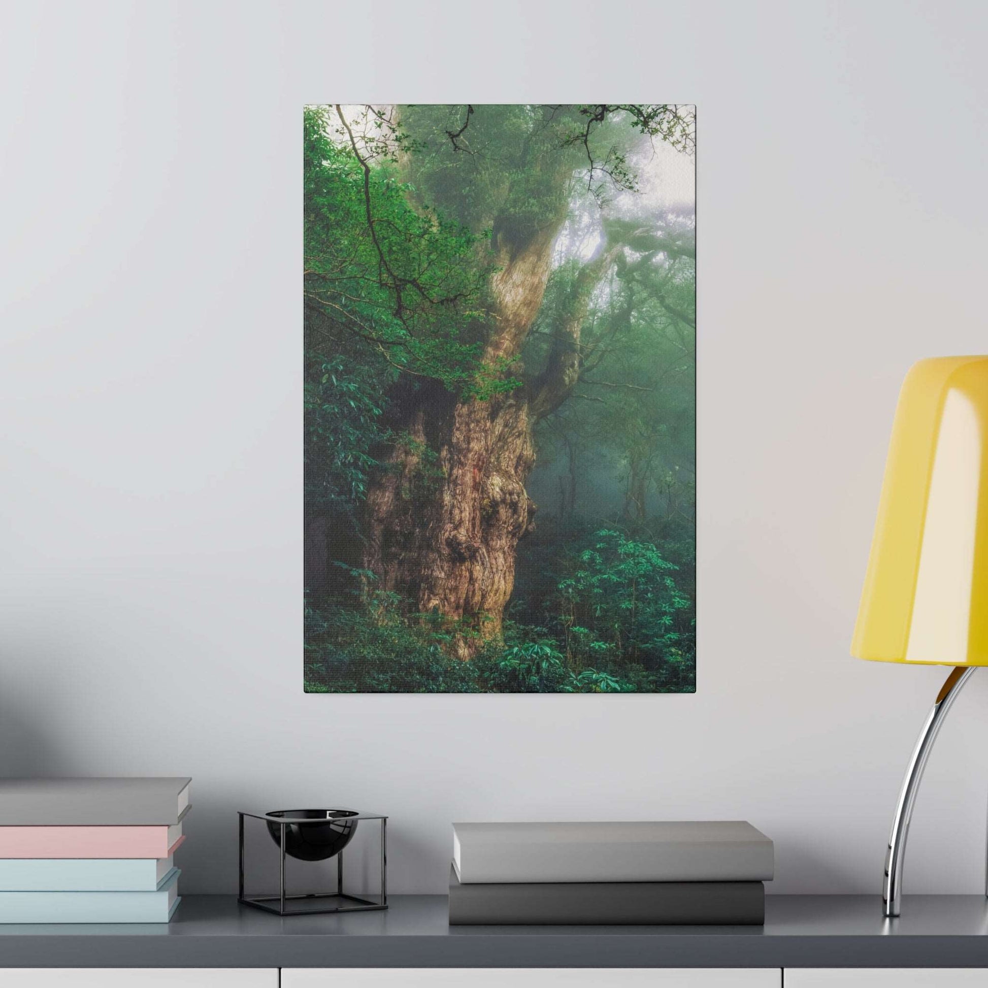 Vertical canvas print of an ancient, moss-covered tree trunk surrounded by dense green forest and mist.