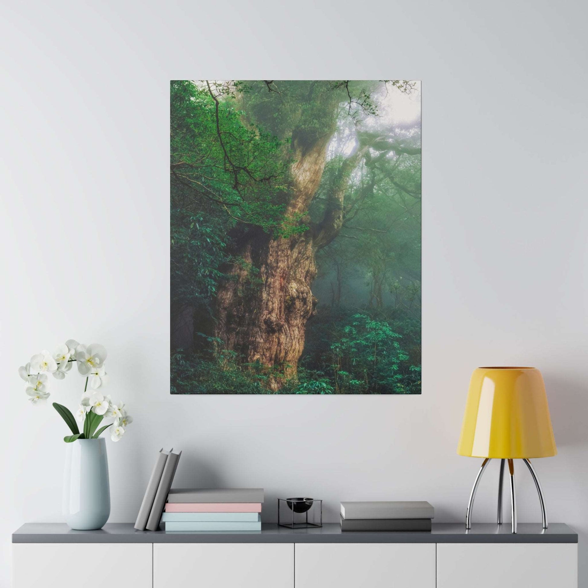 Canvas art print of a massive ancient tree trunk surrounded by green, misty forest foliage.