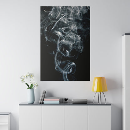 Tall rectangular wall art showing white smoke swirling on a black background, hung above a white cabinet with a yellow lamp, vase, and