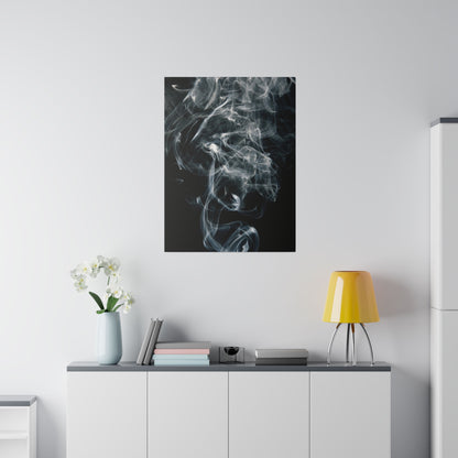 Vertical black poster of swirling white smoke hangs above a white cabinet, with a yellow lamp and white orchid vase.
