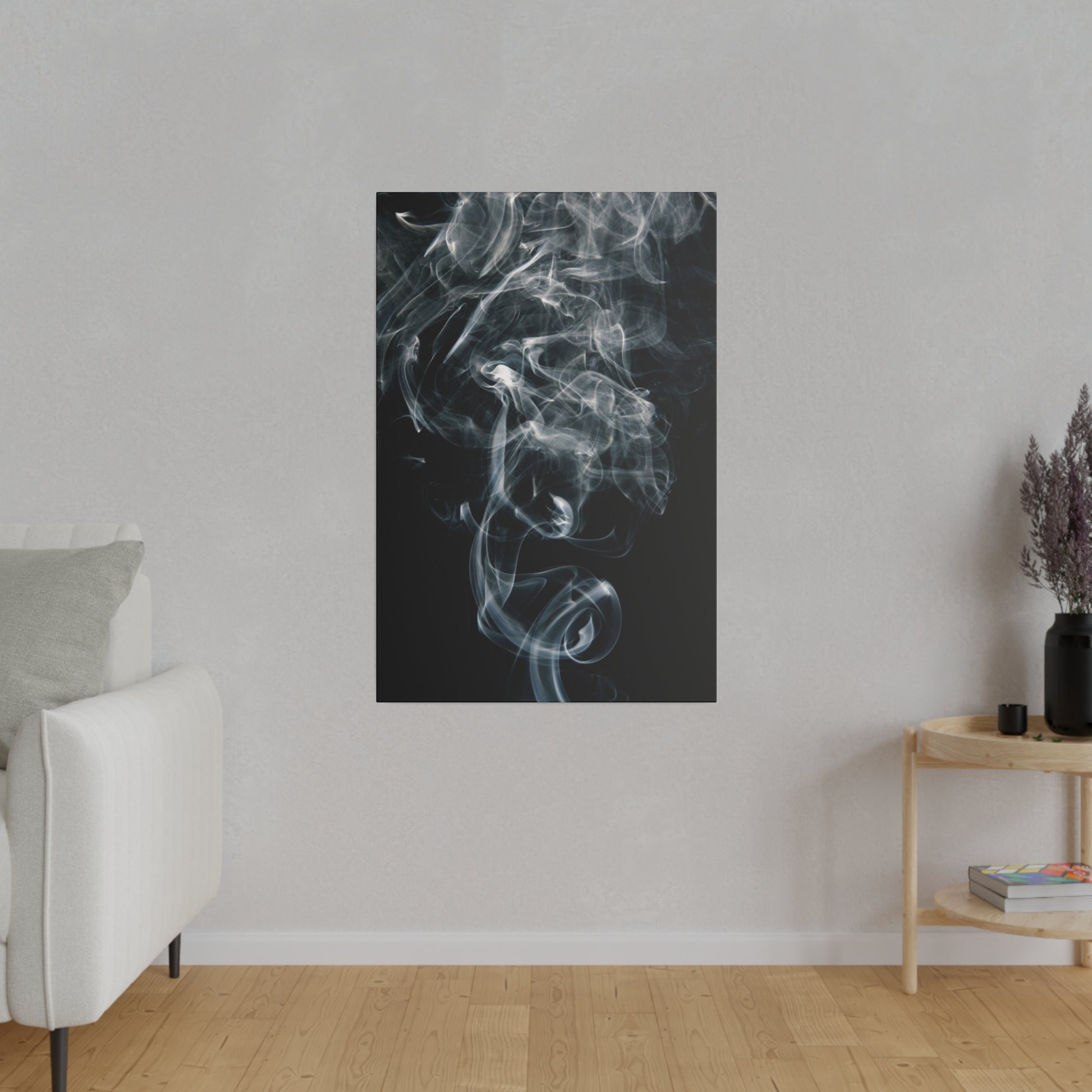 Vertical black canvas with white smoke wisps on a dark background, hung on a light gray wall in a minimalist living room.