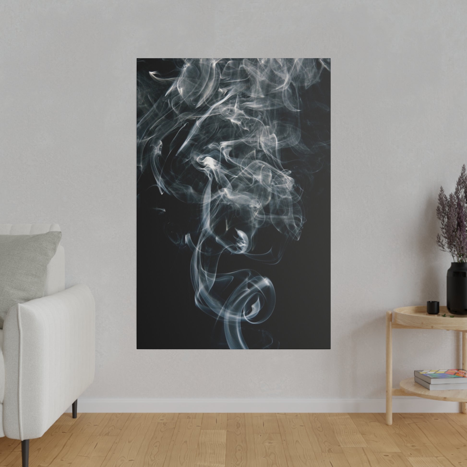 Vertical black wall art poster with wispy white smoke swirls on a dark background, hung on a light gray wall.