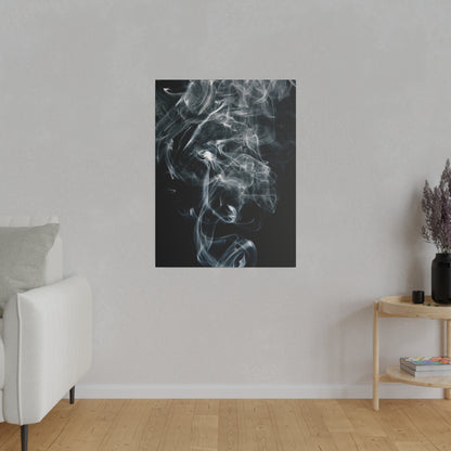 Vertical black canvas print showing white smoke wisps swirling against a dark background, mounted on a light gray wall.