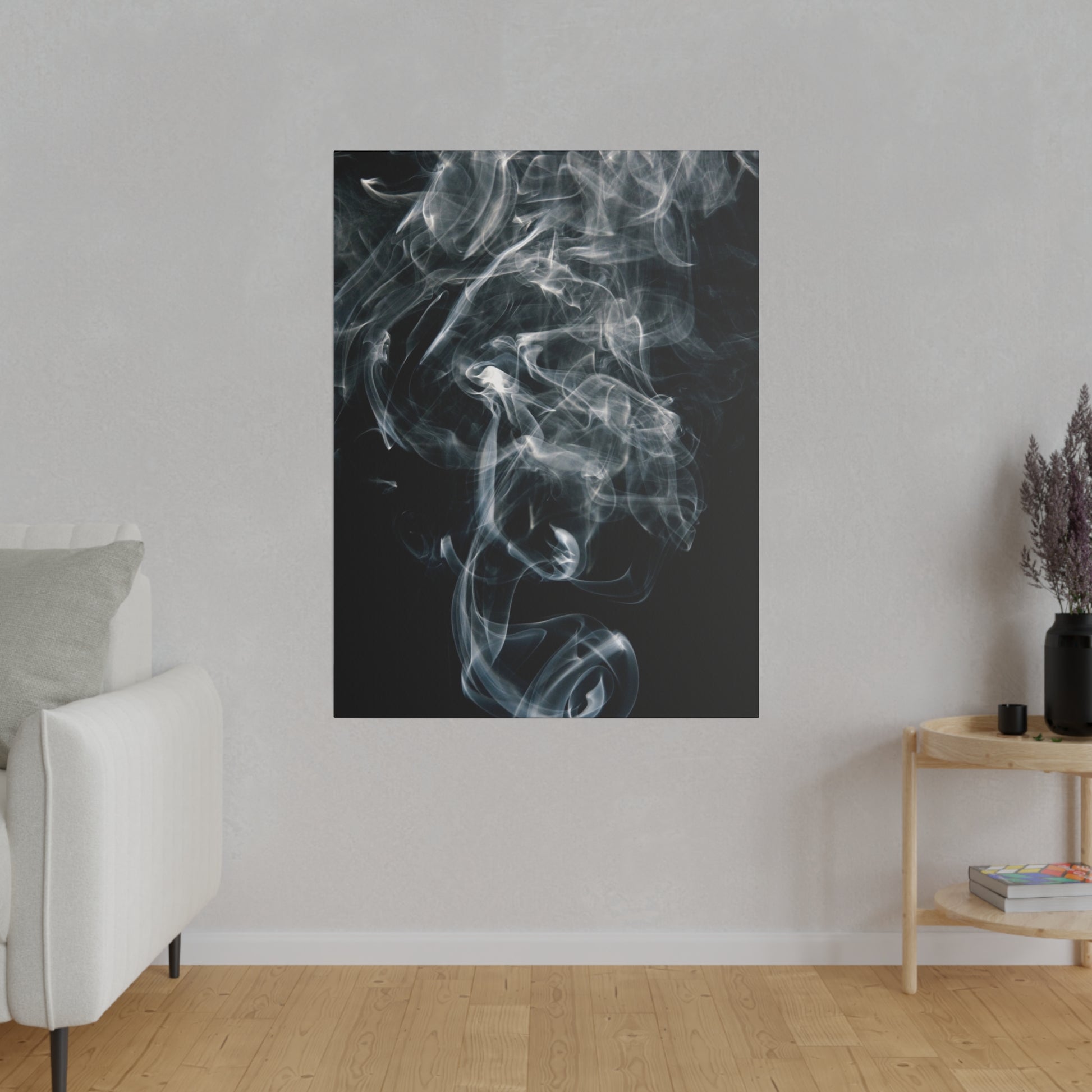 Vertical black canvas print of swirling white smoke, mounted on a light gray wall in a contemporary living room.