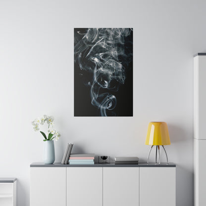 Black poster with white smoke pattern hanging above a white sideboard with a vase of orchids, books, and a yellow lamp.