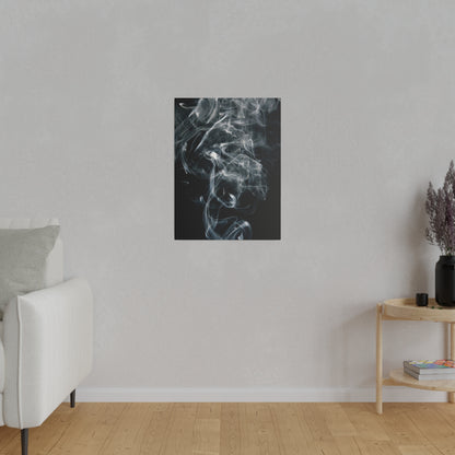 Vertical black artwork with white smoke hangs on a light gray wall above a white sofa in a minimalist living room.