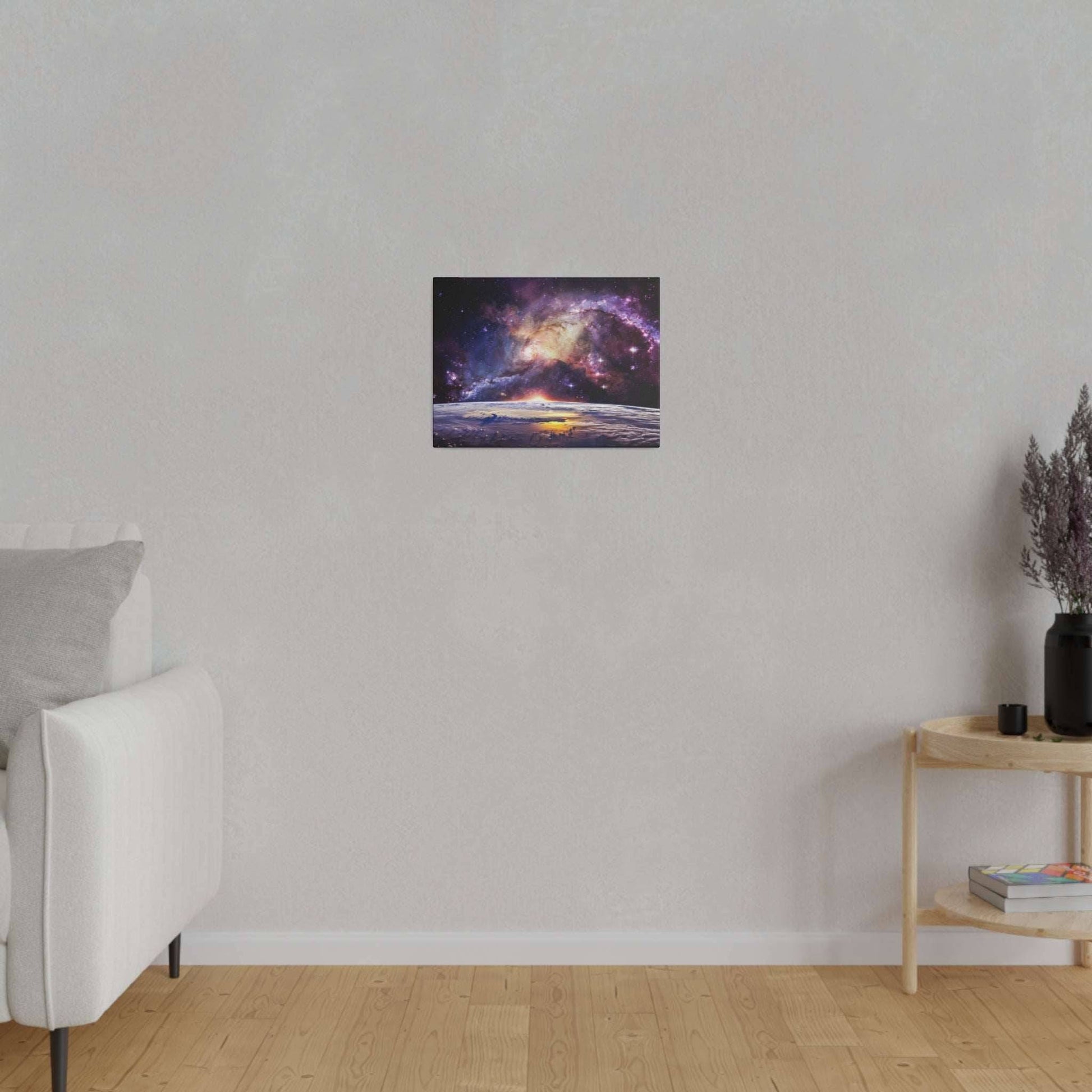 Small square canvas art showing a colorful galaxy over a dark horizon, mounted on a light gray wall.