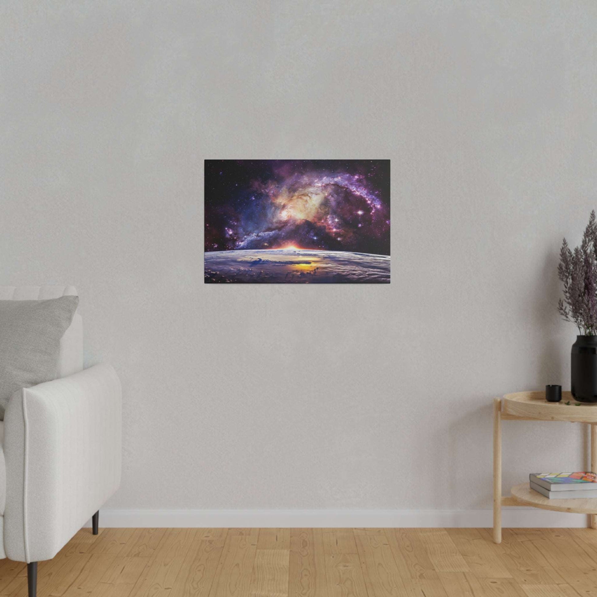 Canvas print of a nebula over a planetary horizon, with purple, pink, and yellow hues, mounted on a light gray wall.