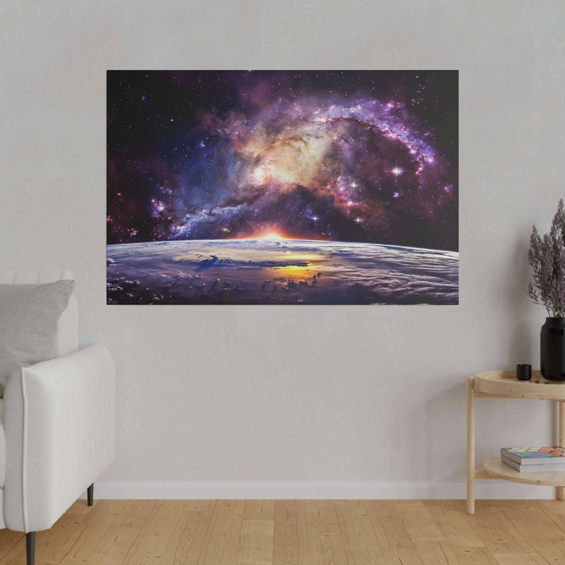 Canvas art showing a colorful galaxy above Earth's horizon at sunrise, mounted on a gray wall.