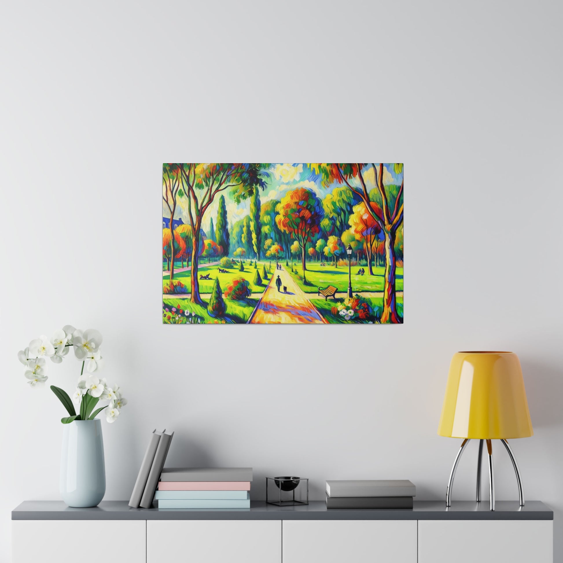 Colorful landscape painting of a park with trees and a central path hangs on a light gray wall above a console table.