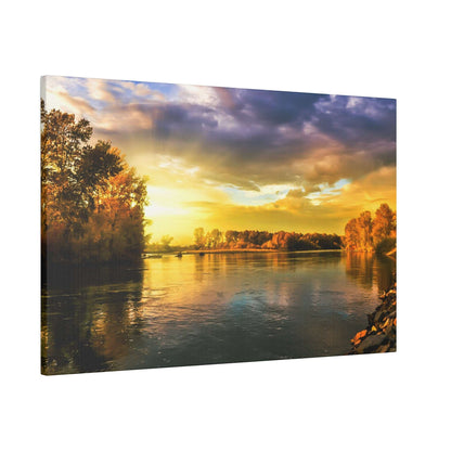 River with calm water reflecting a golden sunset and trees along the shoreline on both sides.