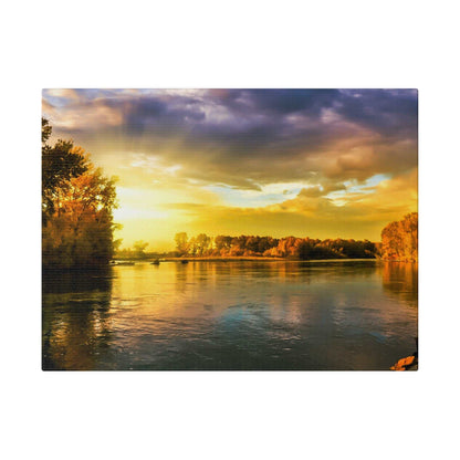 Sunset over a calm river with autumn trees along the banks, golden sky reflecting orange and blue on the water.