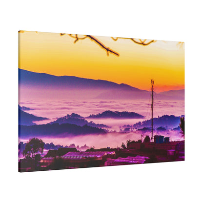 Sunrise over rolling hills with purple fog in the valleys and a small village with a cellular tower.