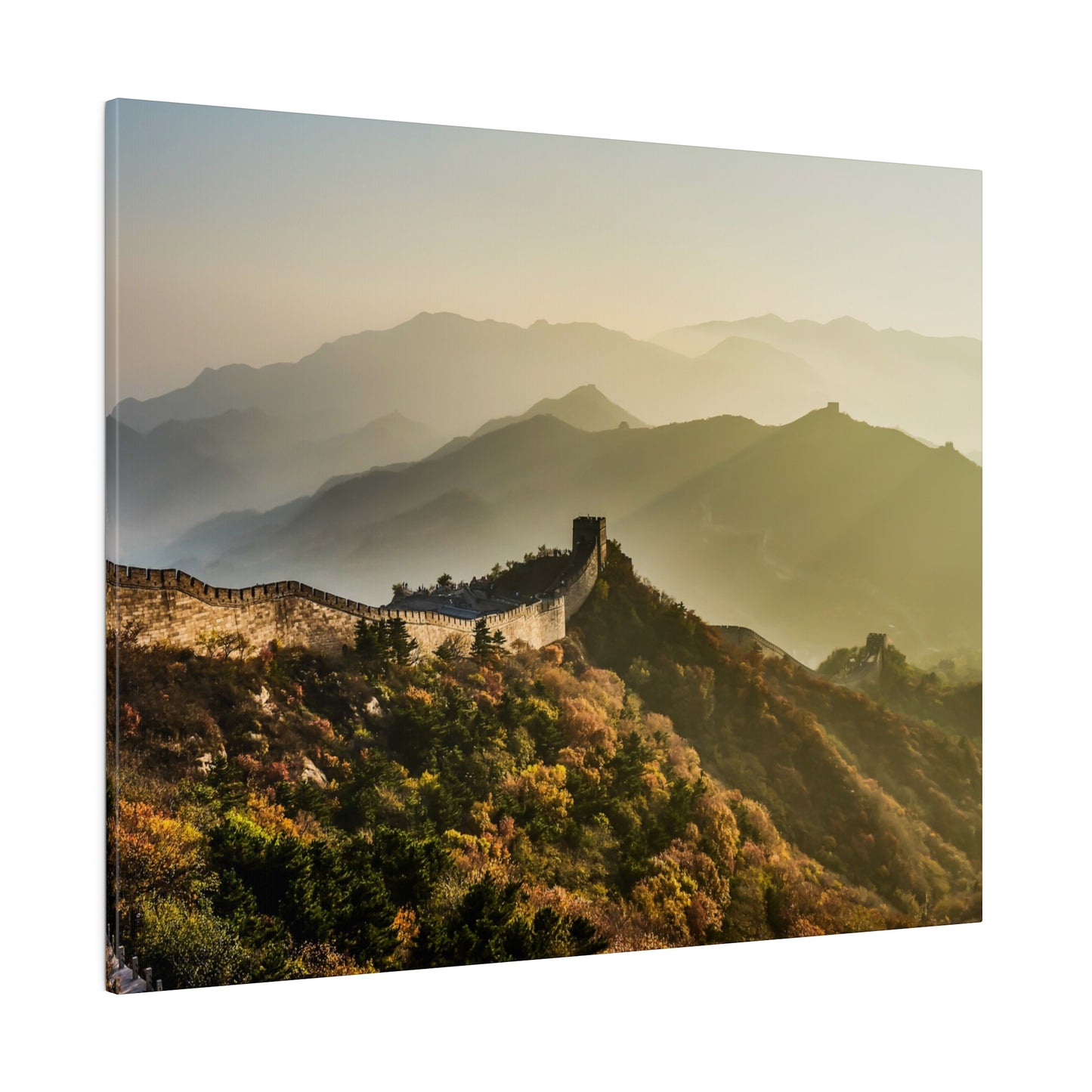 Breathtaking sunrise over the Great Wall of China, illuminating the surrounding scenic landscape.