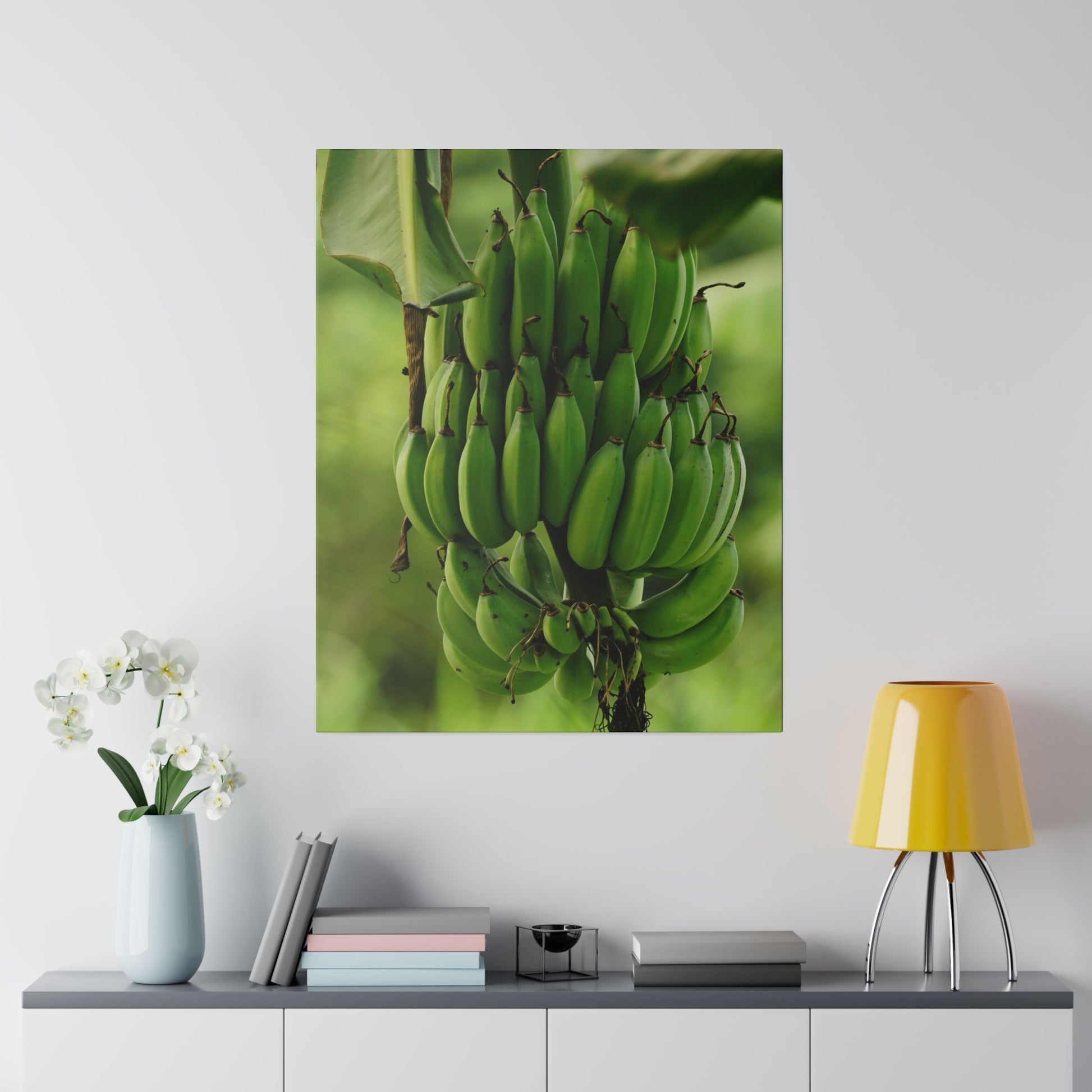 Poster depicting a large cluster of green bananas on a plant with a blurred green background.