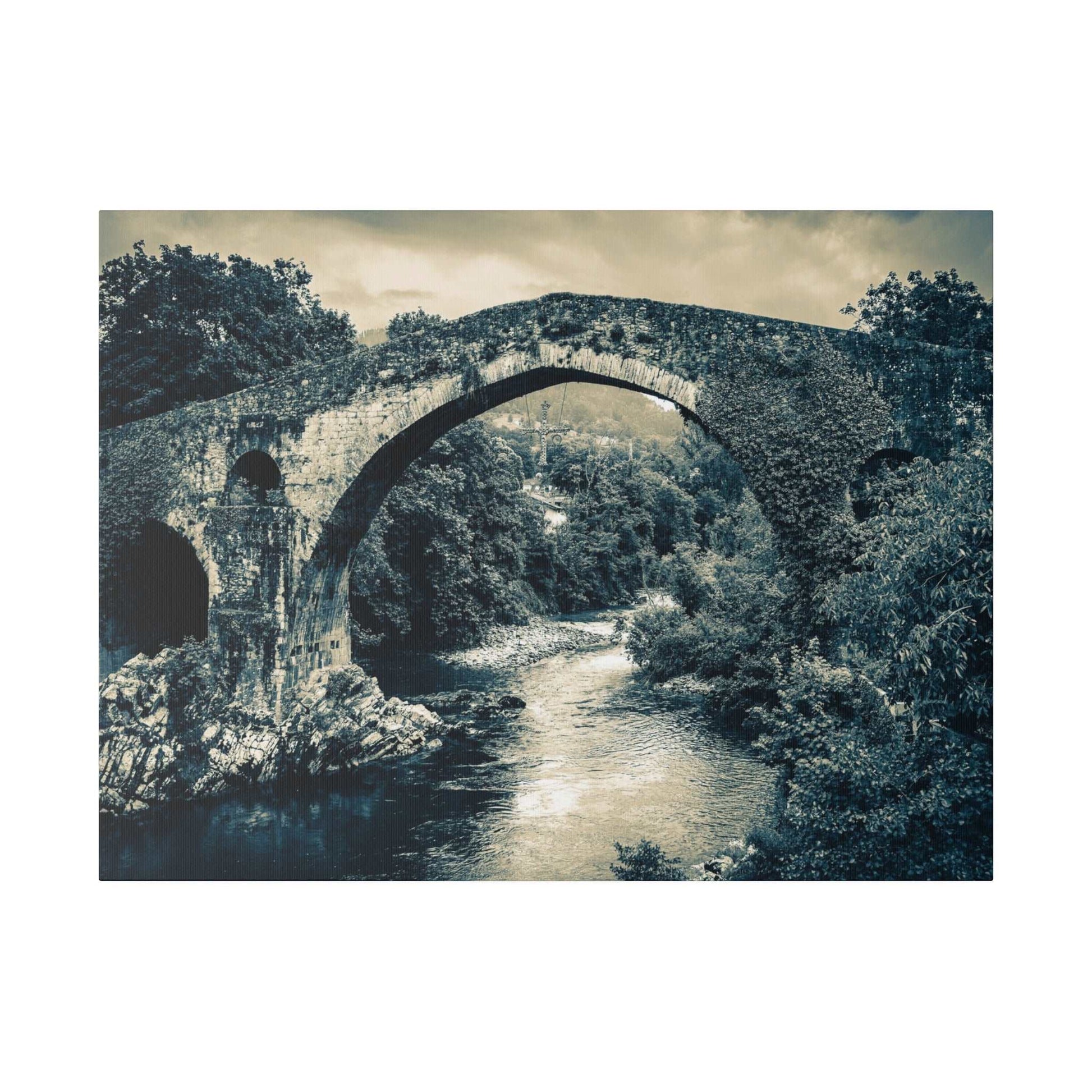 Canvas print of a historic stone arch bridge spanning a river, with dense trees in blue-toned monochrome.