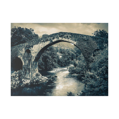 Canvas print of a historic stone arch bridge spanning a river, with dense trees in blue-toned monochrome.
