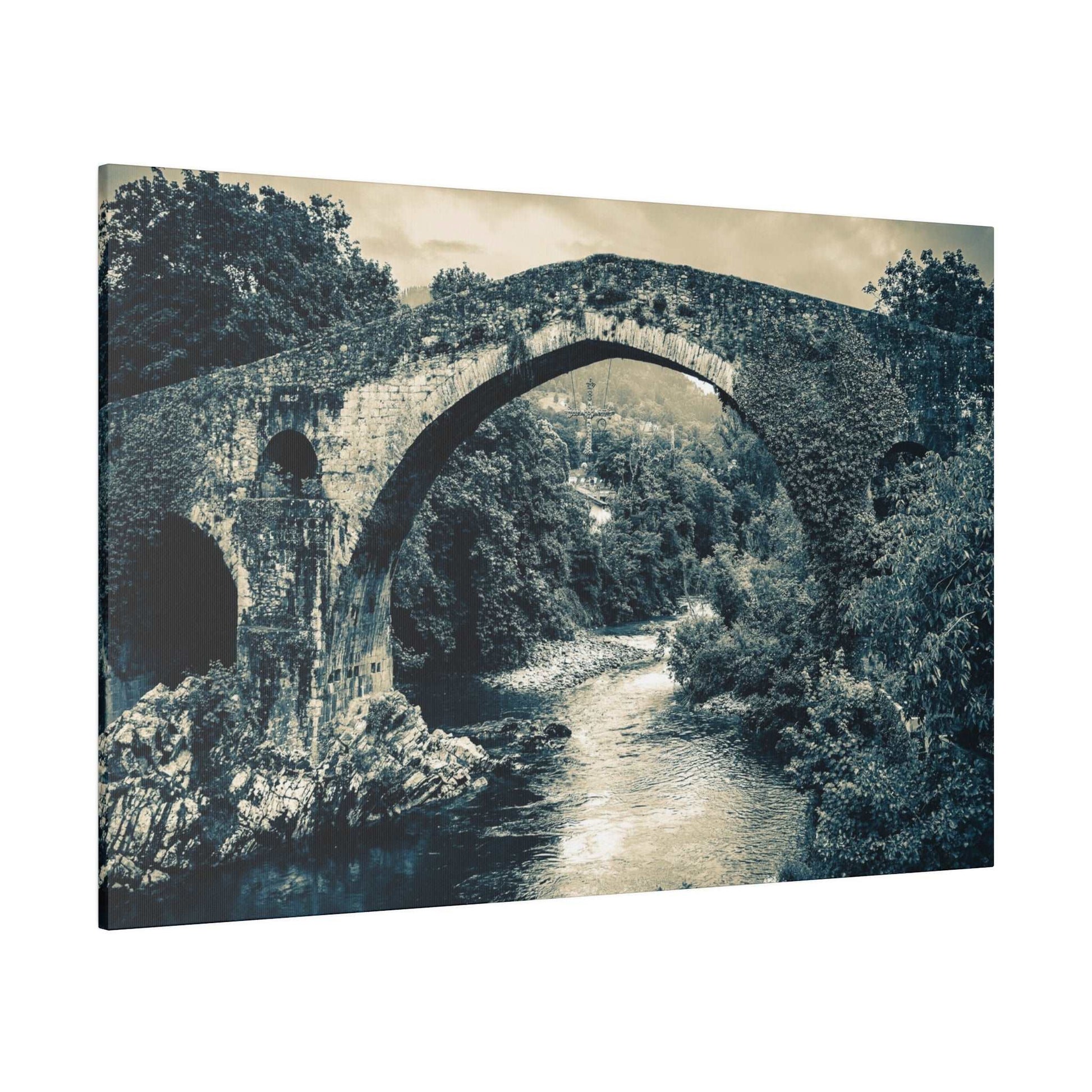 Black-and-white canvas print of an ancient stone arch bridge over a river, surrounded by trees.