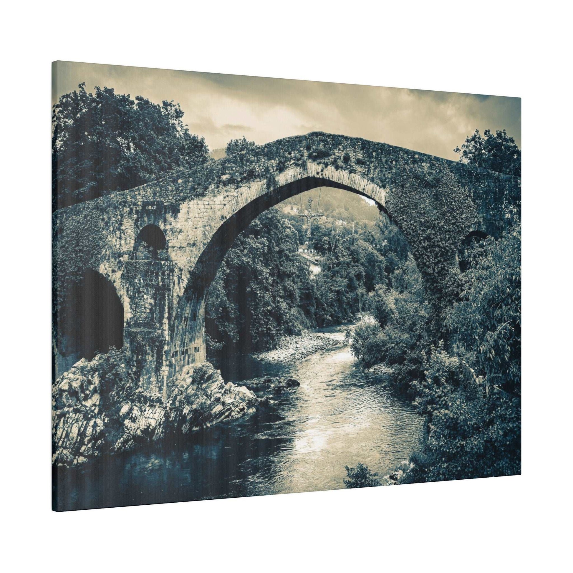 Canvas print of a historic stone arch bridge spanning a river, with dense trees on both banks in a blue-toned monochrome.