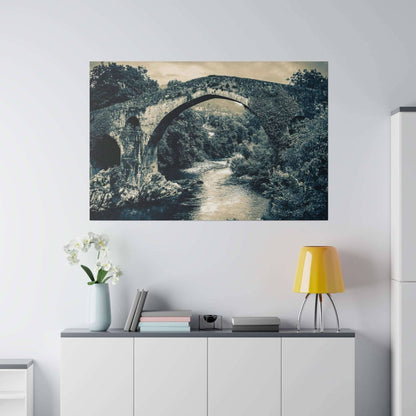 Black-and-white canvas print of a historic stone bridge arching over a river, surrounded by dense trees.
