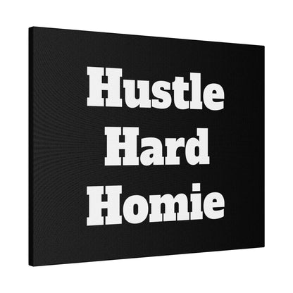 Black wall art canvas with bold white lettering reading “Hustle Hard Homie” in three stacked lines.