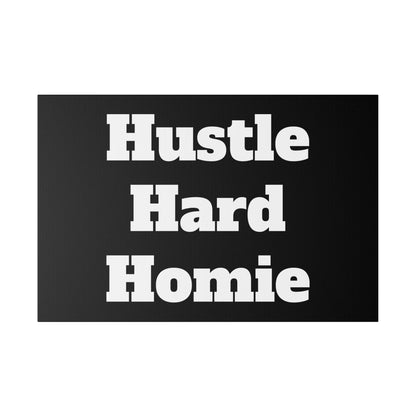A black rectangular sticker with bold white text reading "Hustle Hard Homie.