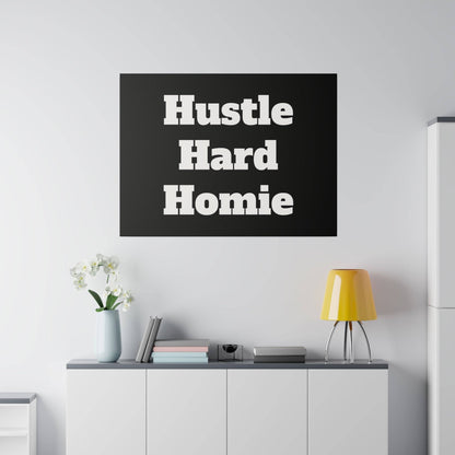 Black square wall art with bold white text "Hustle Hard Homie" hanging above a white cabinet in a modern living room.