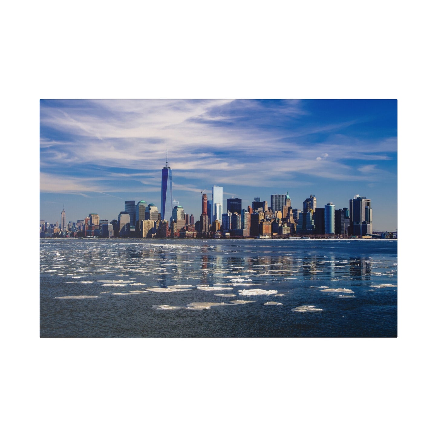 Iconic view of New York City’s waterfront with towering skyscrapers and floating ice on the river.