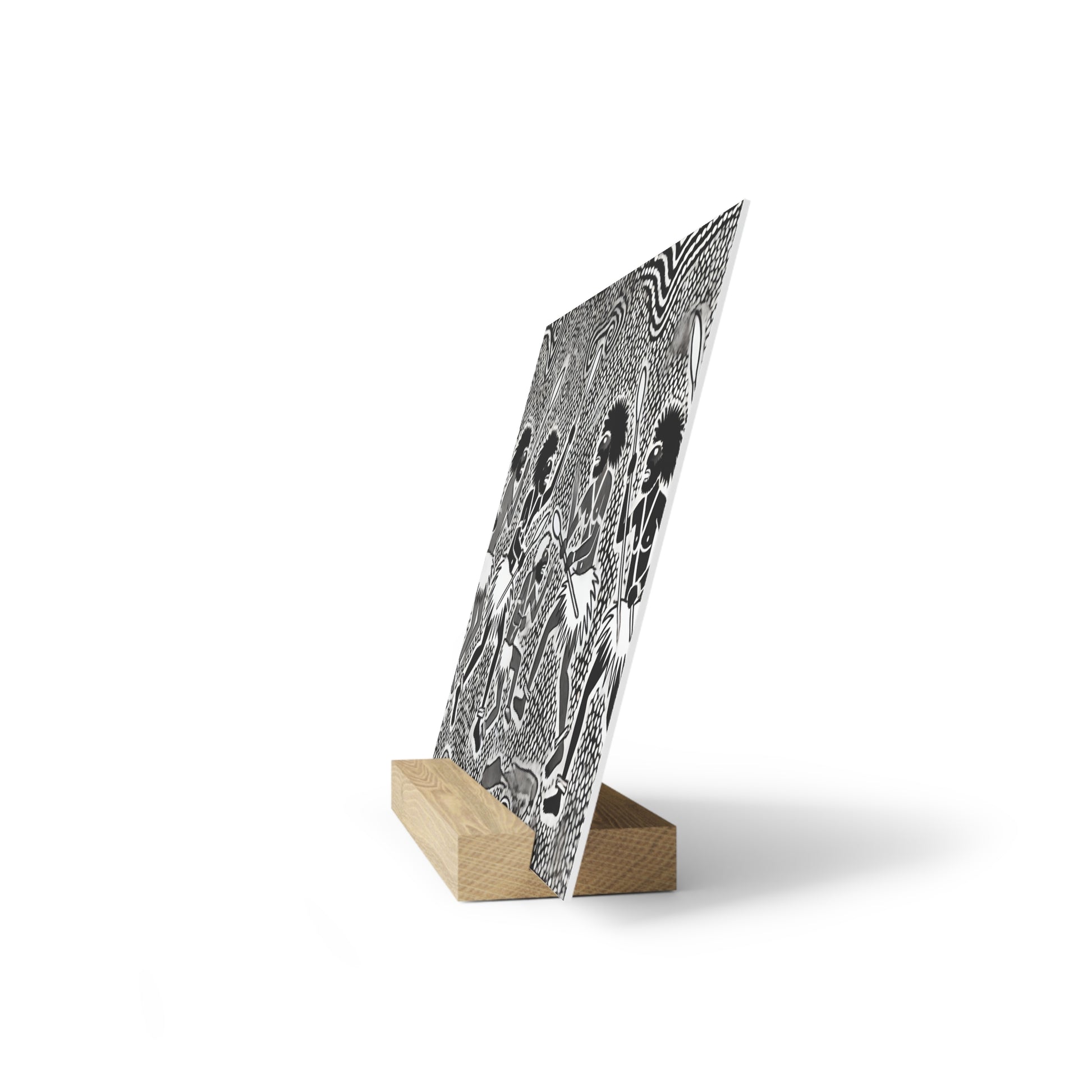Black-and-white patterned poster on a small wooden stand, tilted against a white background.