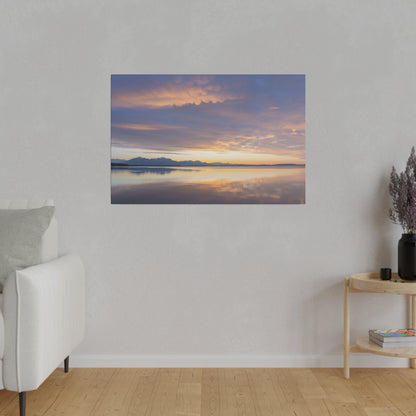 Framed landscape art of a calm lake at sunset, with an orange-purple sky and distant mountains reflected on the water.
