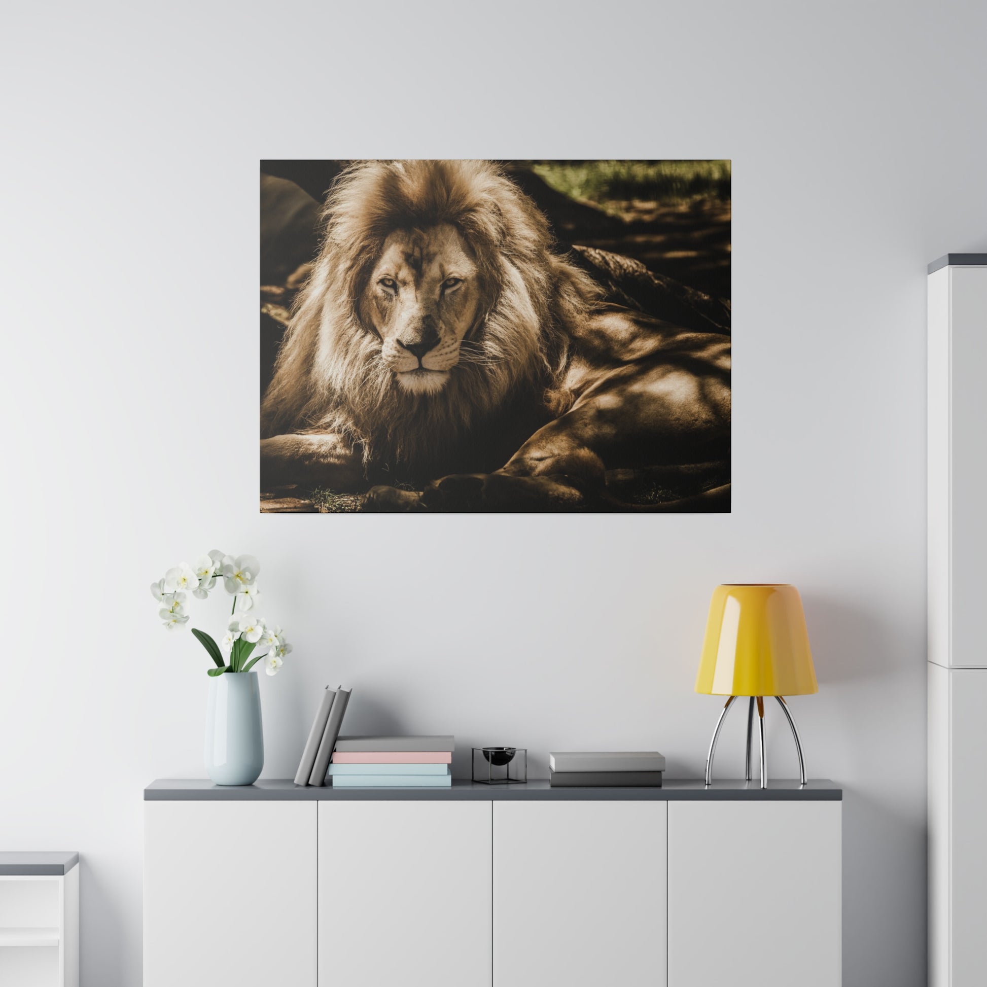 A lion relaxing under the shade of a tree, with its majestic mane and powerful build visible in the soft light.